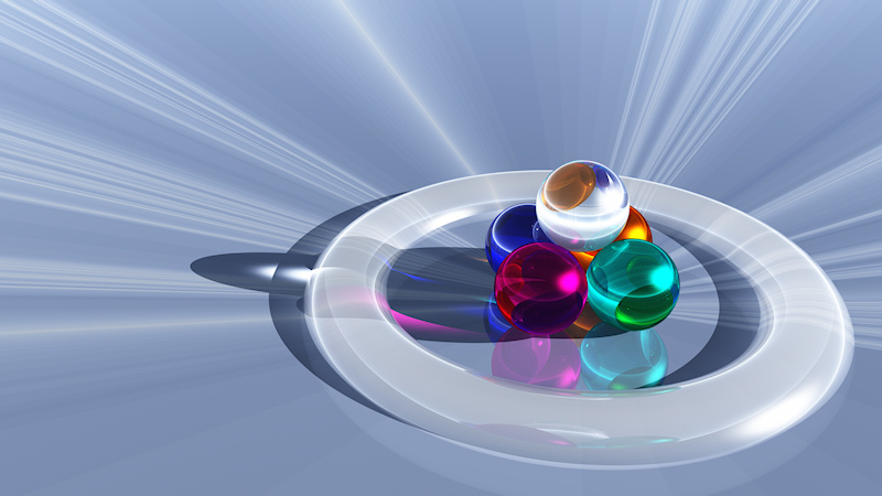 Five colorful spheres of blue, pink, turquoise, orange, and diamond glass stand in a pyramid encircled by a translucent white ring. They sit on a mind-bending background of pale blue and white rays that converge right under the five crystal balls.