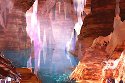 Warm sunlight streams into immeasurable halls, filled with an everlasting music of water that tinkles into pools. Gems and crystals and veins of preci...
