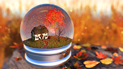 Inside a 'snow globe' is an autumn landscape with a cottage overshadowed by maple and cherry trees. The surrounding field is filled with tall green an...