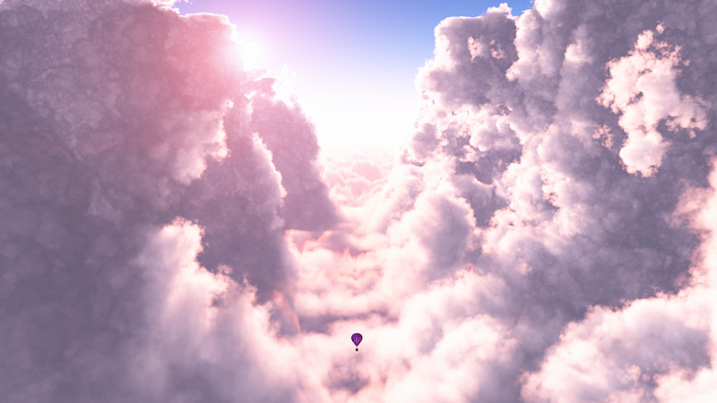 A solitary hot-air balloon floats through the pale pink canyon between towering clouds. The sun, low in the pastel sky, glows behind the edge of the billows, sending streams of bright light toward the viewer.